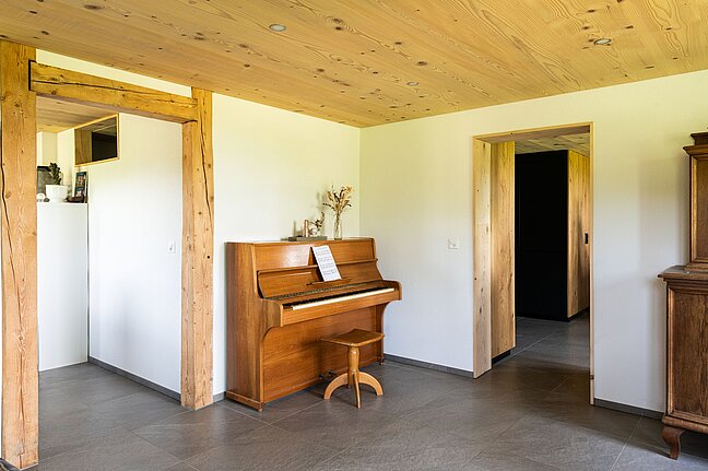 Emmentaler Weisstannentäfer Decke oberhalb im Wohnzimmer mit Klavier.